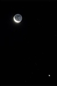 Faint Star Near A Moon Brightly Illuminate With Earthshine (click to enlarge)